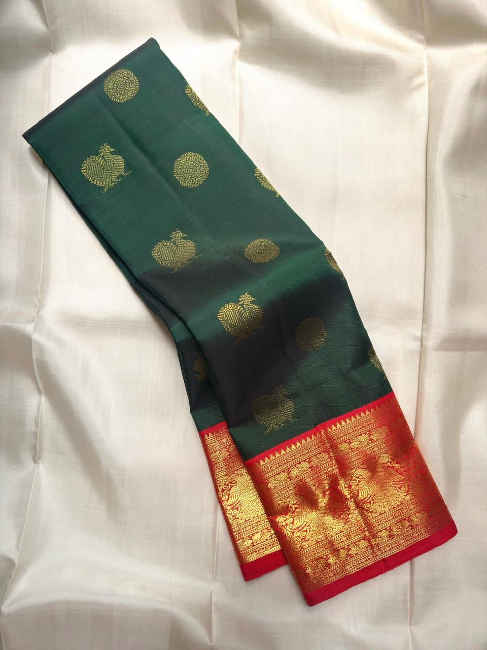 Bottle green handwoven pure silk Kanchipuram butta saree with vermilion border