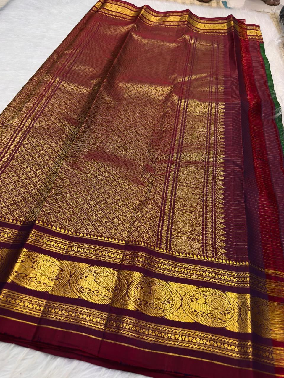 Bottle Green Kanjivaram Zari Kattam saree — maroon elephant medallion border close-up