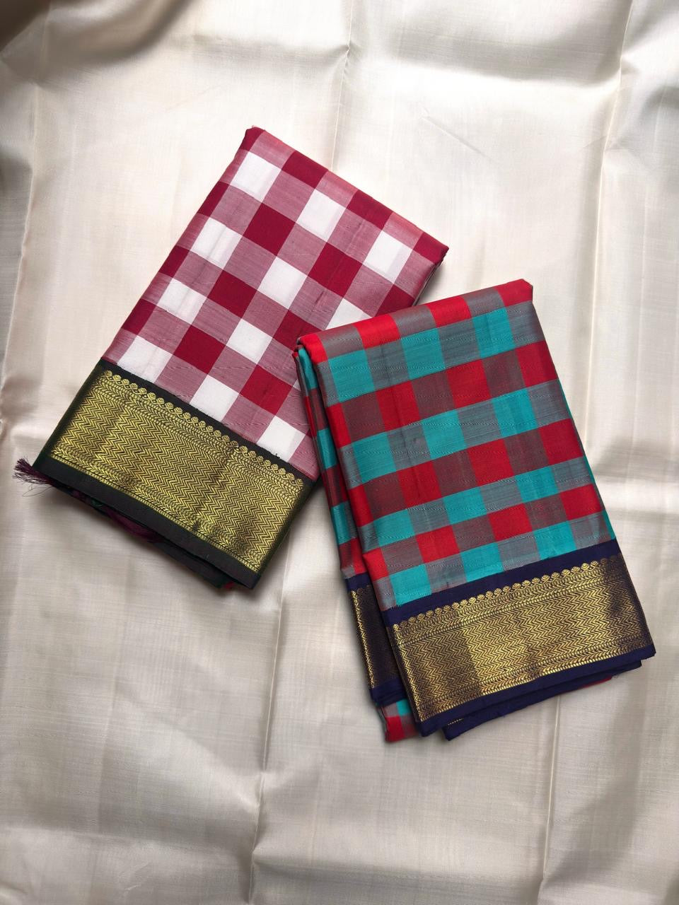 Broad gold zari border with chevron-like weave and dark green edge.
