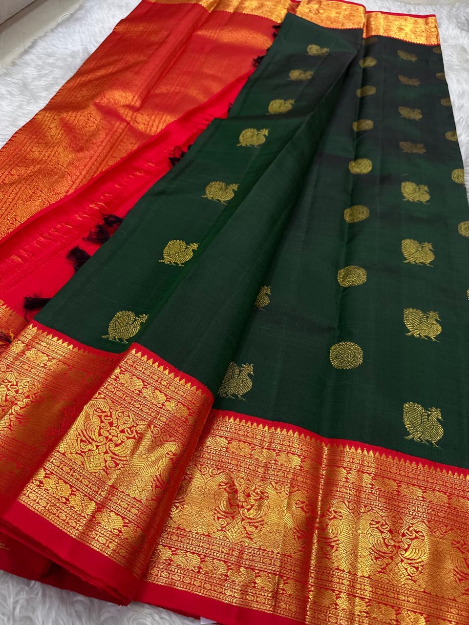 Bottle green Kanchipuram silk saree with Gandaberunda detail on the vermilion border