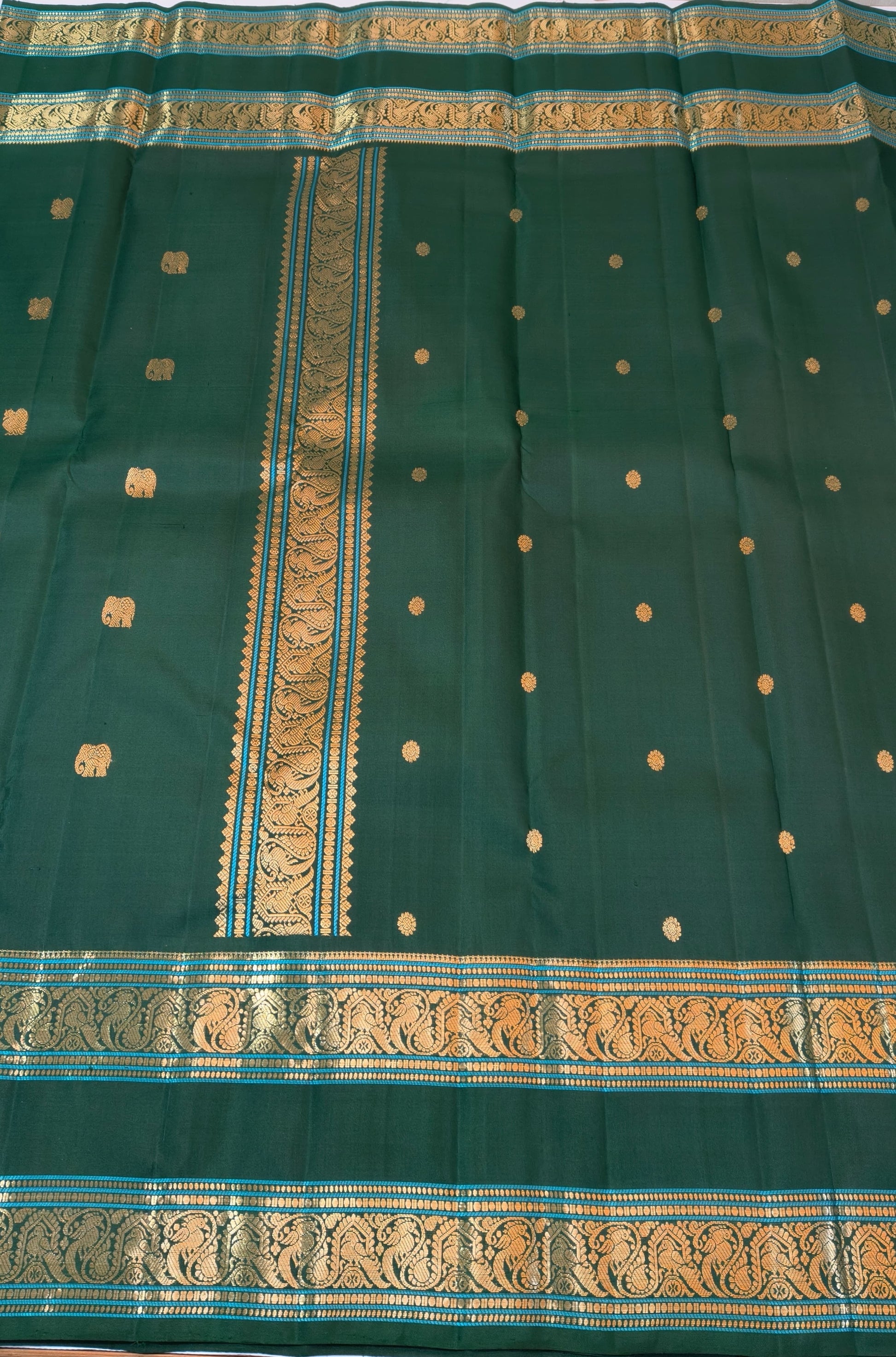Bottle Green Pure Silk Kanchipuram Saree with antique-gold zari buttas and double-sided Rettapet border.