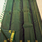 Bottle green pure silk Vairaoosi saree with fine parallel zari lines.