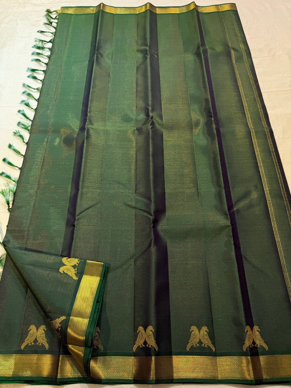 Bottle green pure silk Vairaoosi saree with fine parallel zari lines.