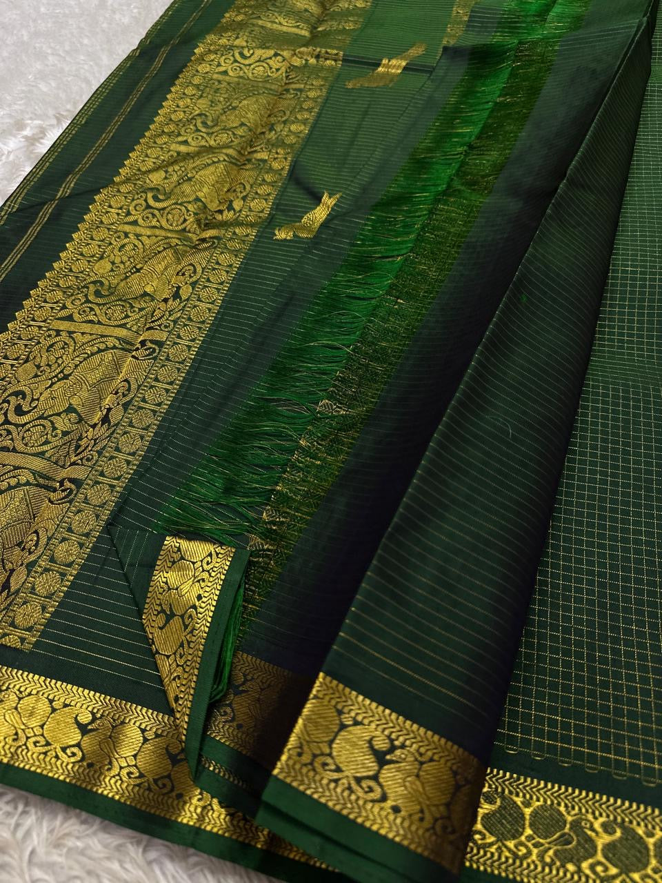 Self-colour pallu of dark bottle green Kanjipuram pure silk saree with cascading Mayil peacock antique gold zari