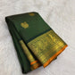 Bottle green Kanchipuram saree body close-up showing Zari Kattam grid and gold zari buttas