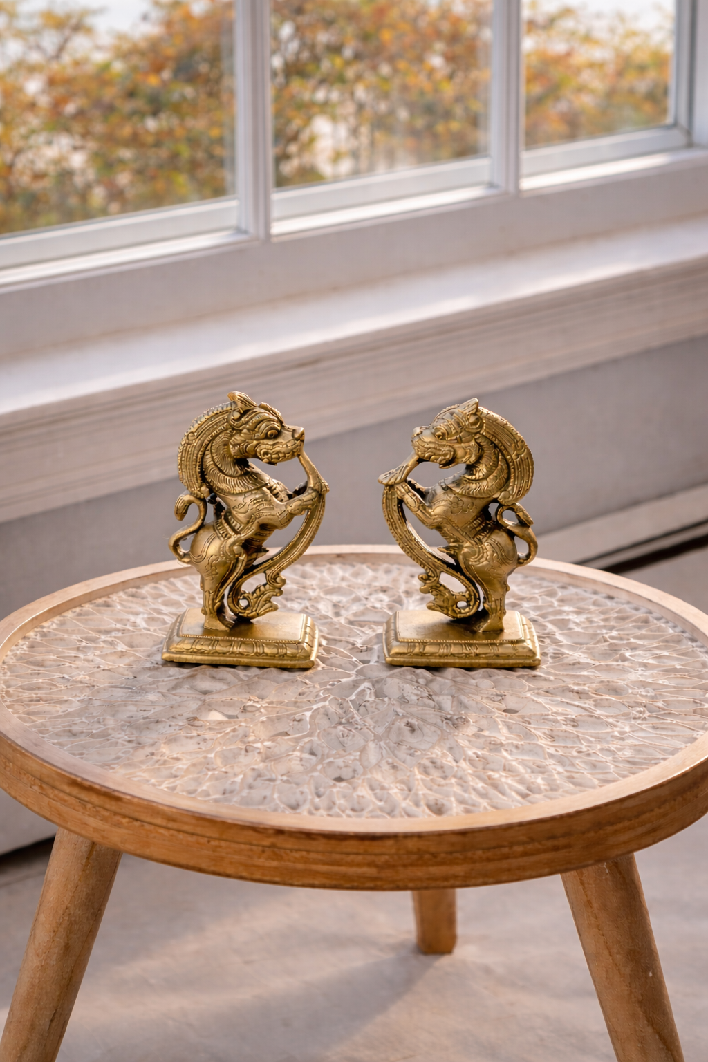 5 inch pure brass Yazhi figurine pair displayed on marble top table in natural light luxury Indian home decor