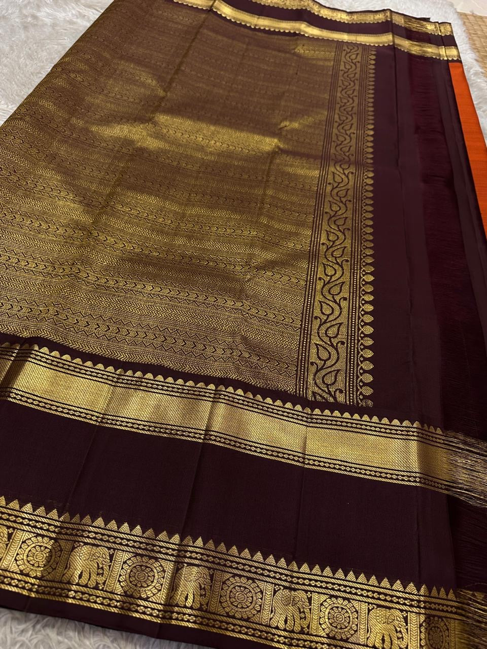 Handwoven brick red Kanchipuram silk saree draped view