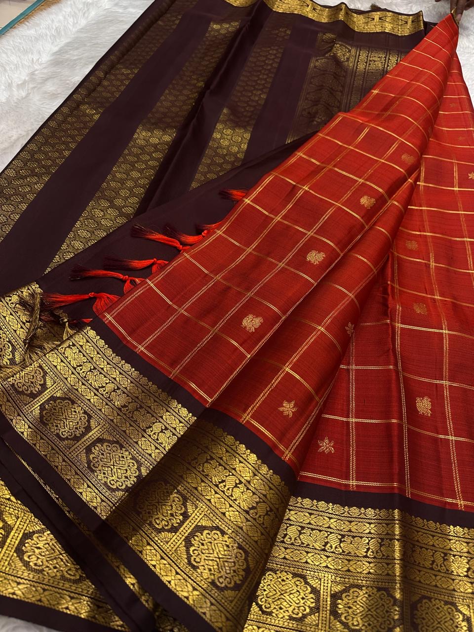Gold zari kattam grid detail on brick red silk saree