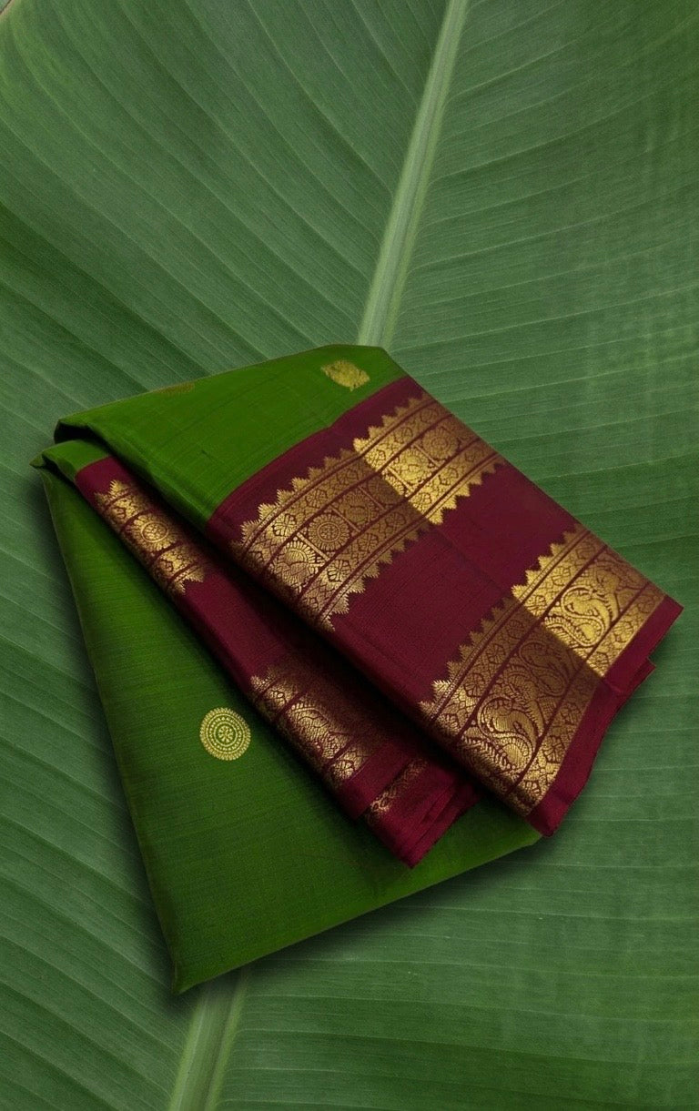 Bright green Kanchipuram silk saree with deep ruby rettapet border and traditional zari Idam Living