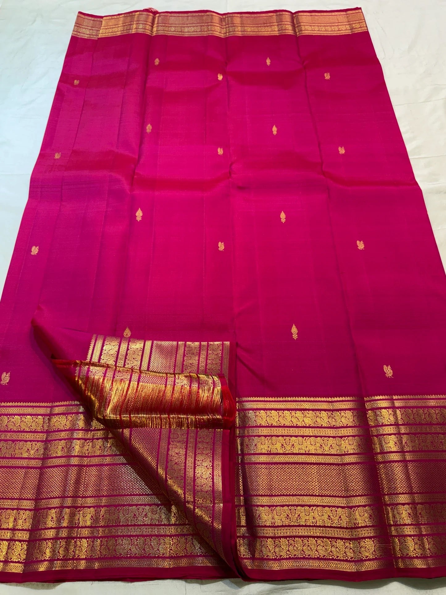 Rani Pink pure mulberry silk Kanchipuram saree with individually spaced traditional zari motifs.