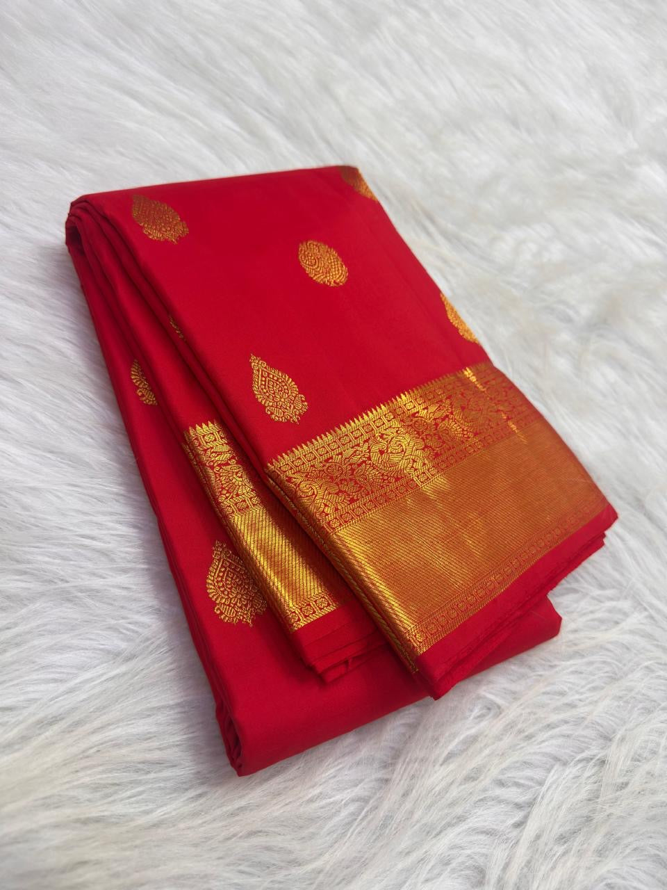 Thick Banarasi-inspired zari border with intertwined peacocks and florals on red Kanjeevaram saree