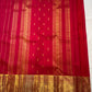 Close border view showing dense gold geometric weaving along the red silk edge.
