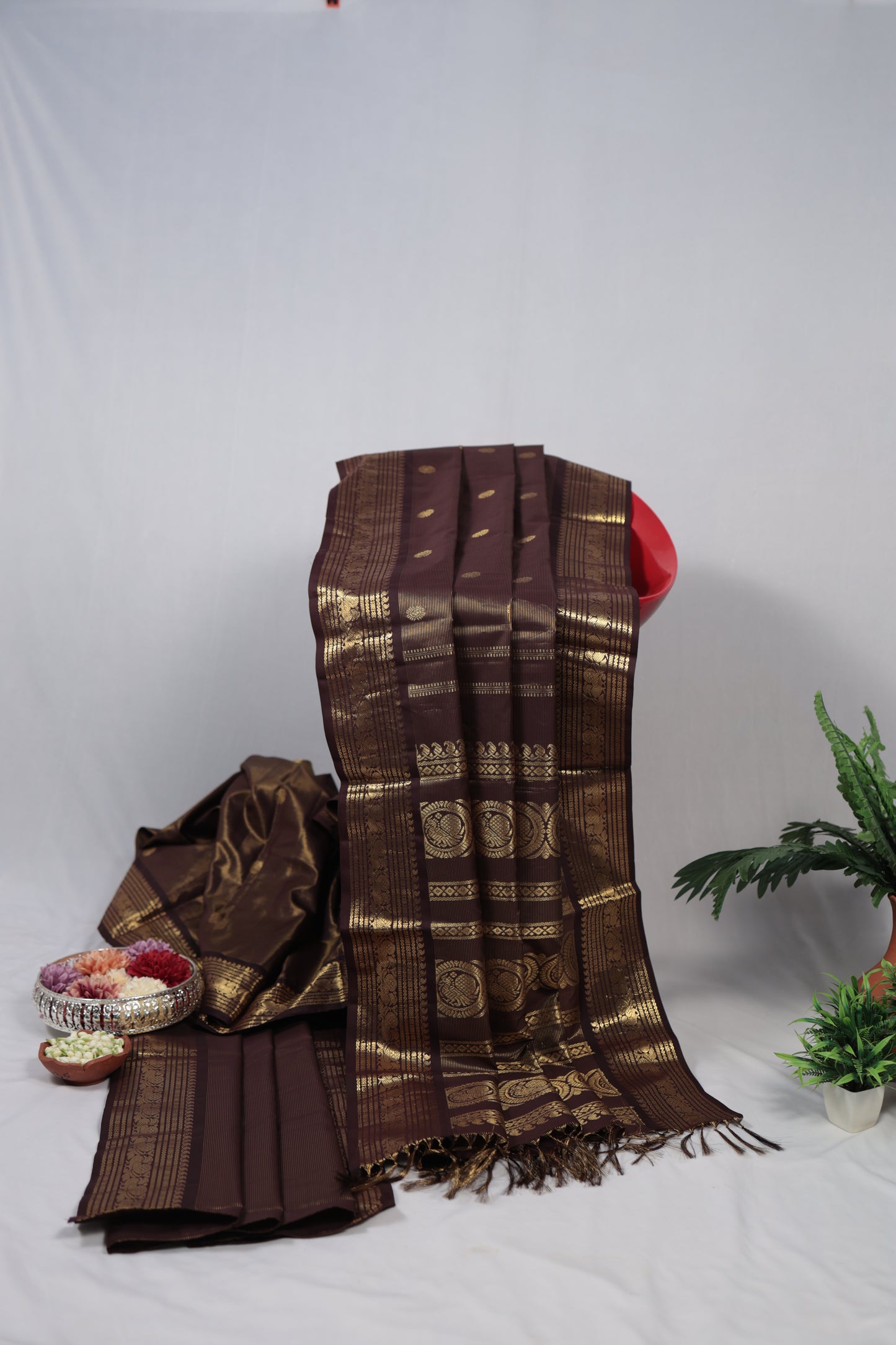 Brown and gold patterned fabric with a decorative headband on a white background