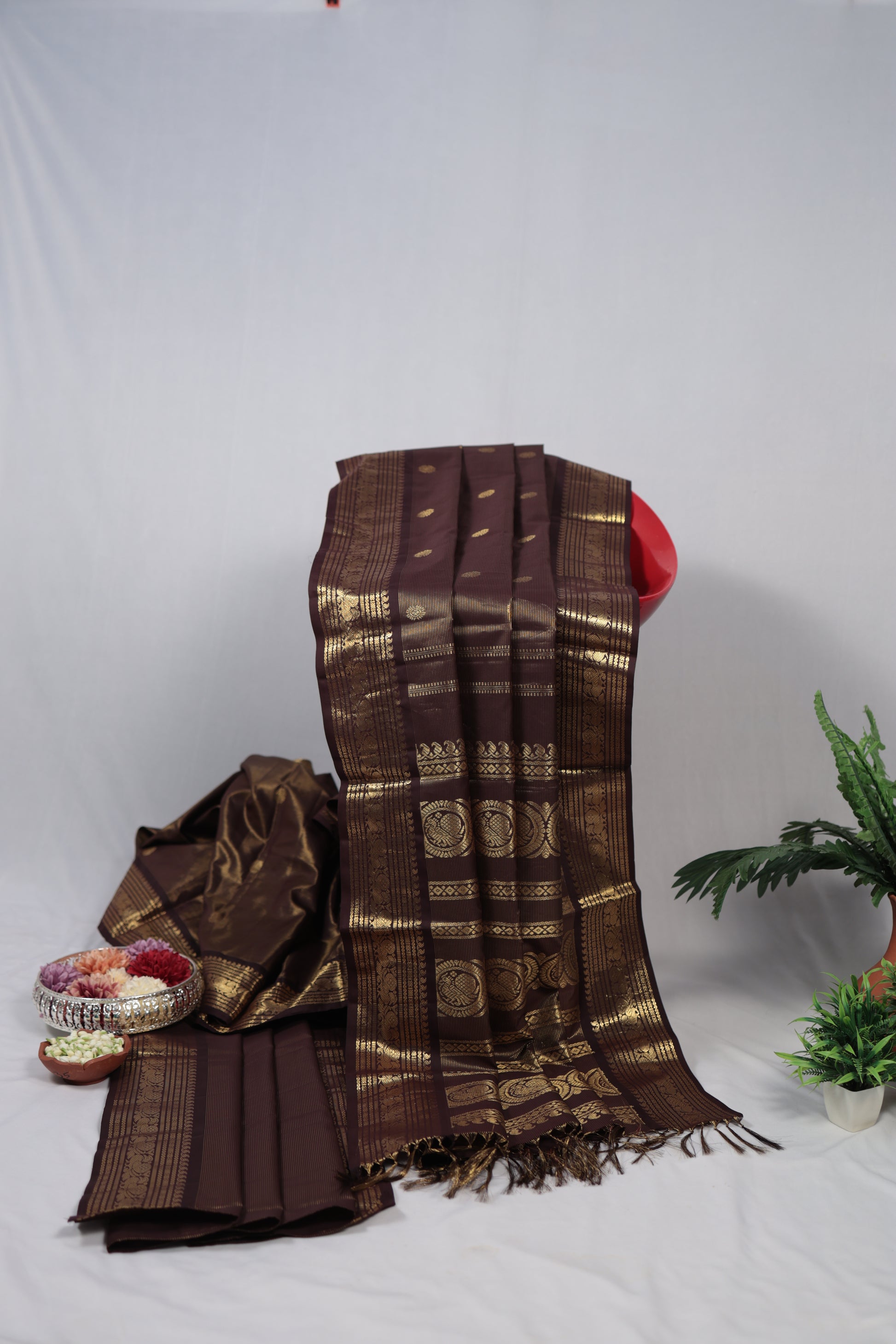 Brown and gold patterned fabric with a decorative headband on a white background