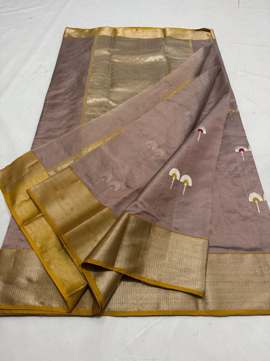 brown silk saree partially opened showing gold border