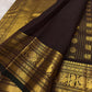 Cinnamon brown Kanjeevaram saree, gold zari checks and zari buttas detail