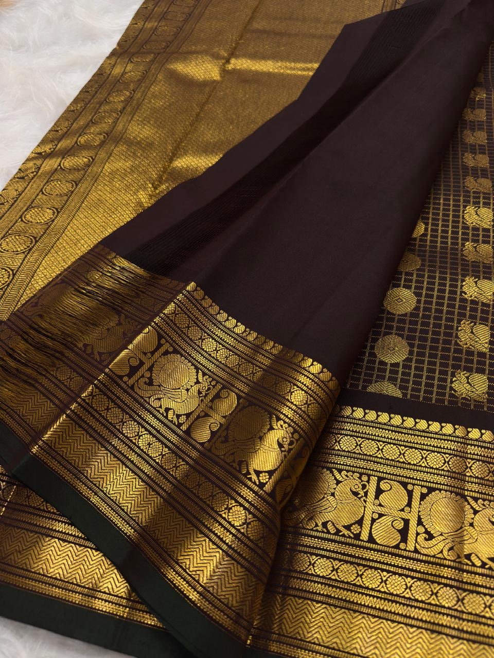 Cinnamon brown Kanjeevaram saree, gold zari checks and zari buttas detail
