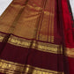 Deep brown Kanchipuram silk with fine Zari Kattam lines and scattered traditional gold zari motifs.