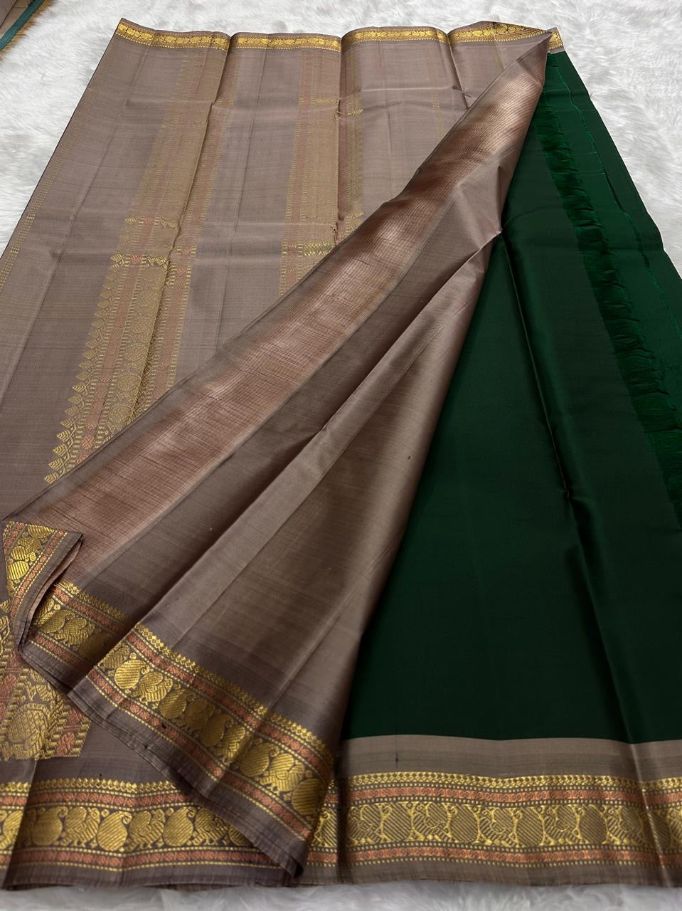 Pure Kanchipuram silk saree draped view focusing on gold zari paisley border, available in the USA