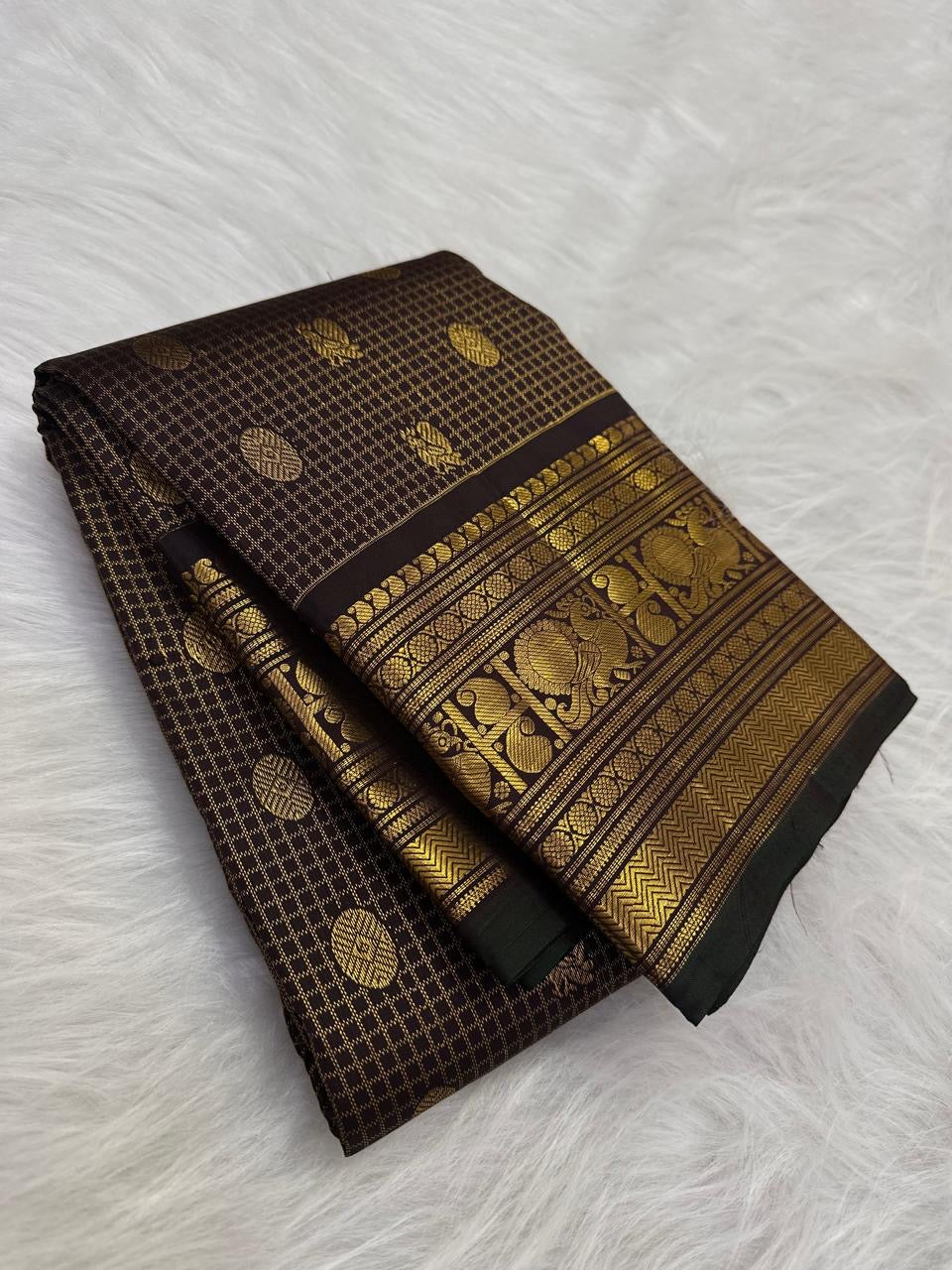 Handwoven lightweight pure silk Kanjivaram saree in deep brown with Zari Kattam body Mayil Chakram butta and ornate antique gold zari border Silk Mark certified