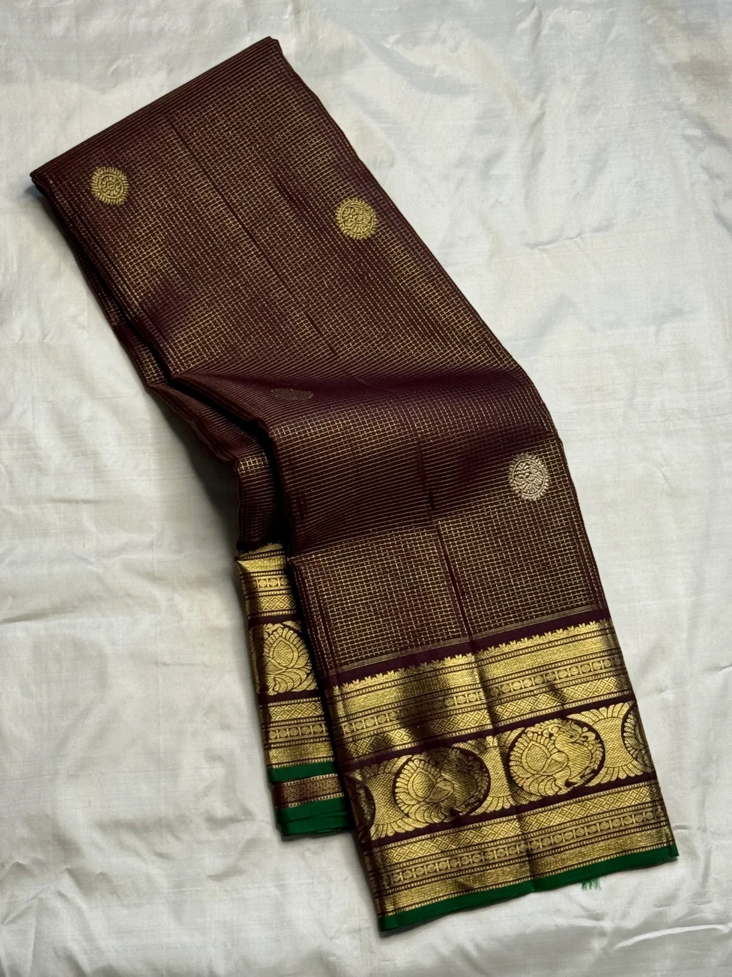 Gold zari peacock-paisley border with green selvedge on brown silk