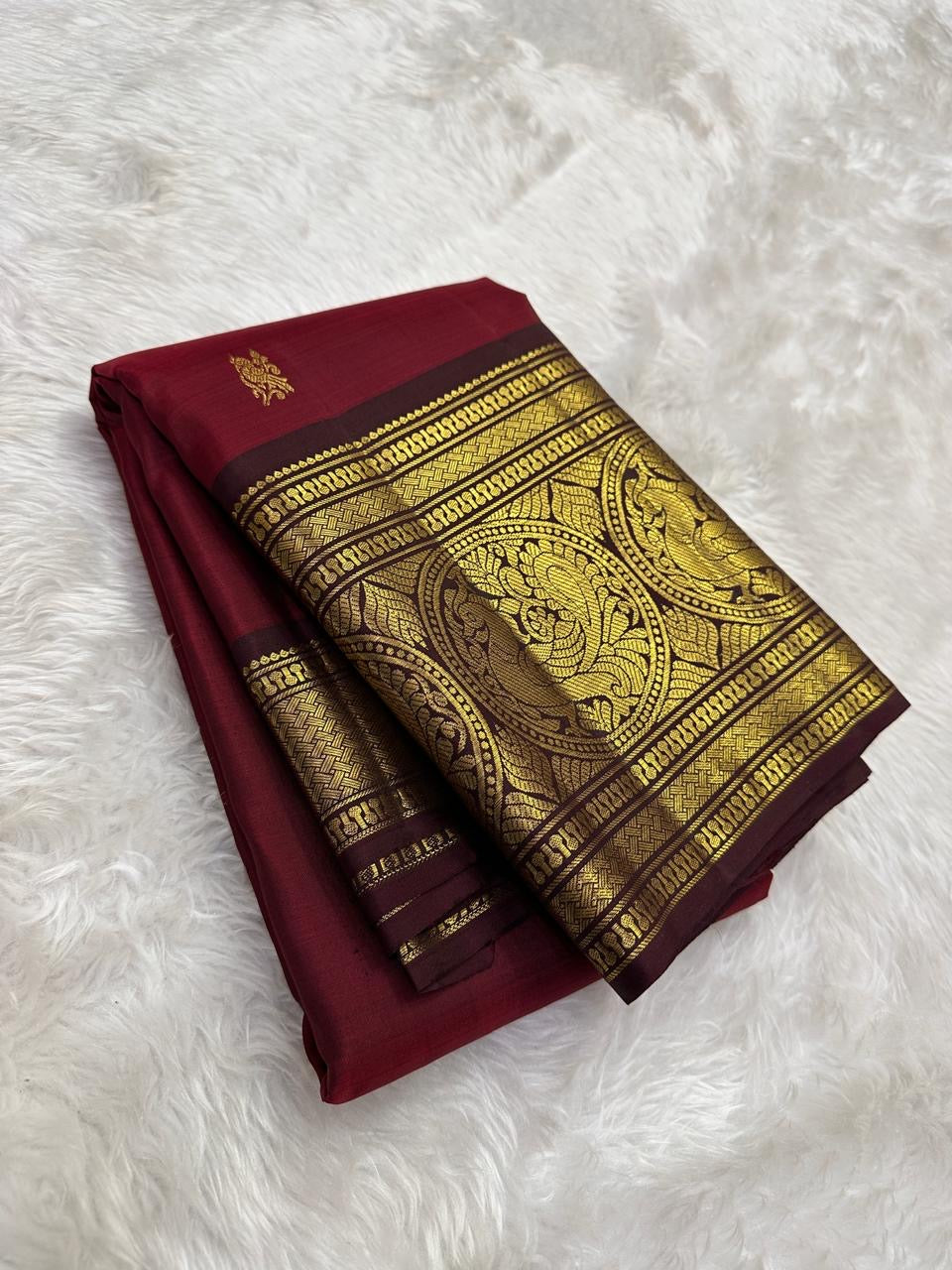 Burgundy red Kanchi silk saree with mayil butta korvai – detail view