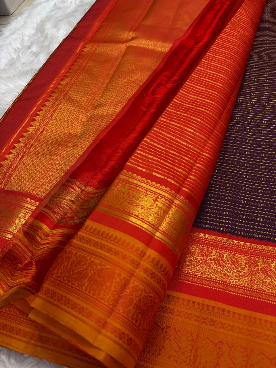 Burnt copper Kanchipuram silk saree with fine horizontal zari stripes across the body