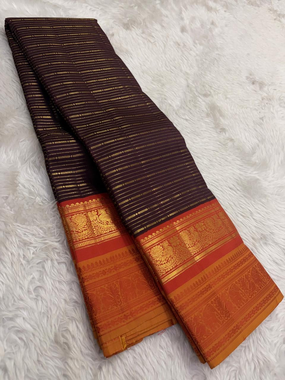 Kanjivaram butta saree in burnt copper with double layered zari and silk thread border