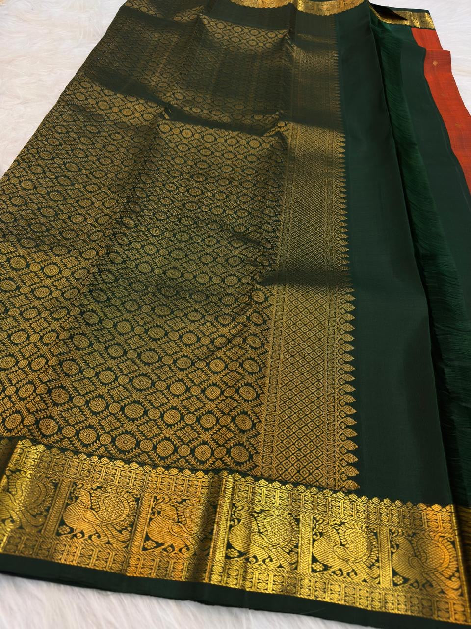 Burnt Orange pure silk KanchiPattu Butta saree with Deep Forest Green Mayil gold zari border
