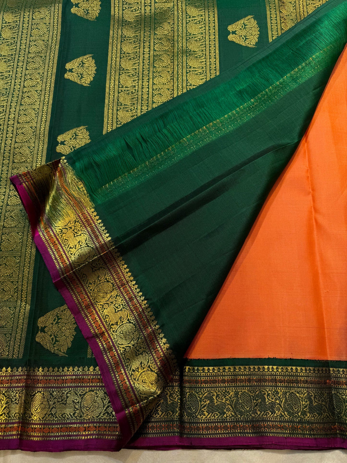 Burnt Orange Kanjivaram saree with Deep Forest Green Gandaberunda zari border