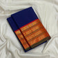 Burnt-orange Kanchipuram border with circular medallion-like gold-zari forms and fine ornamental bands.