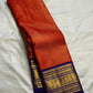 Close view of antique-gold zari lines woven on Burnt Orange Kanjivaram silk.