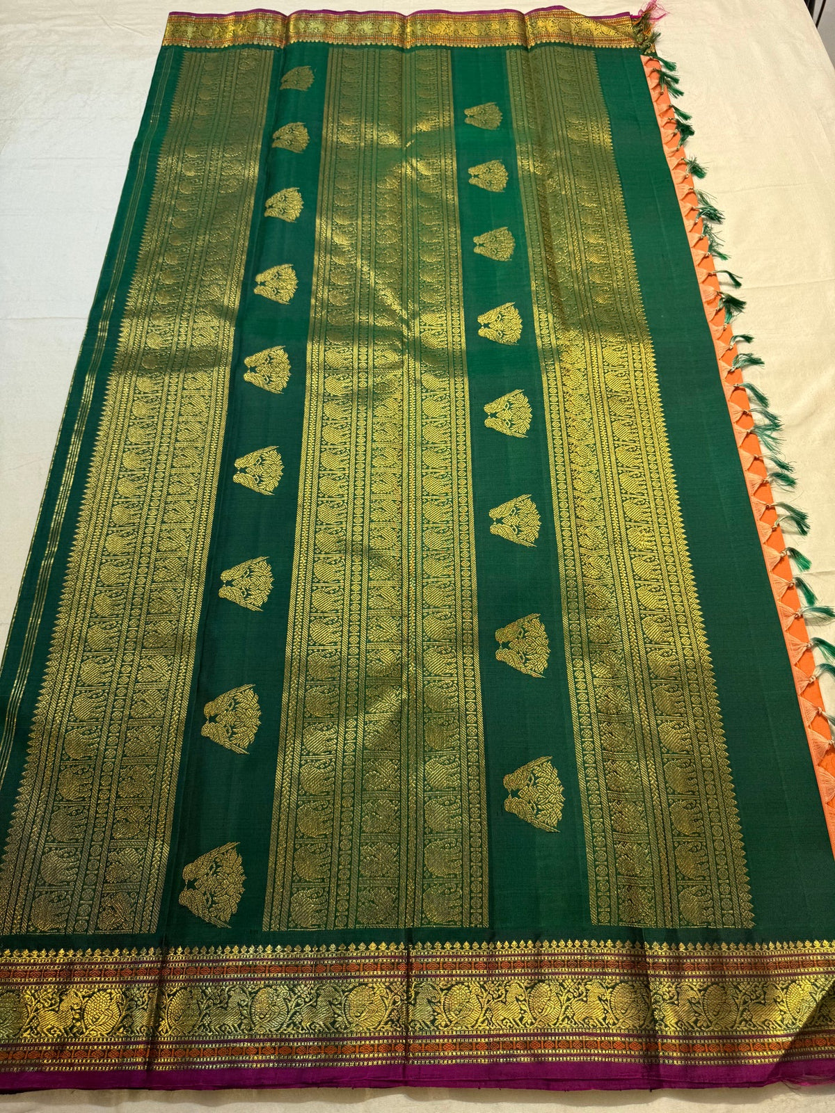 Close view of antique gold Gandaberunda motif on Burnt Orange Kanjivaram silk
