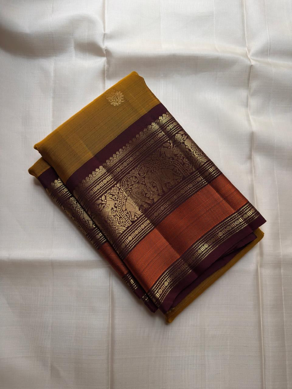 Golden Turmeric pure silk Kanchipuram saree, Butta weave with Deep Aubergine border — body weave close-up