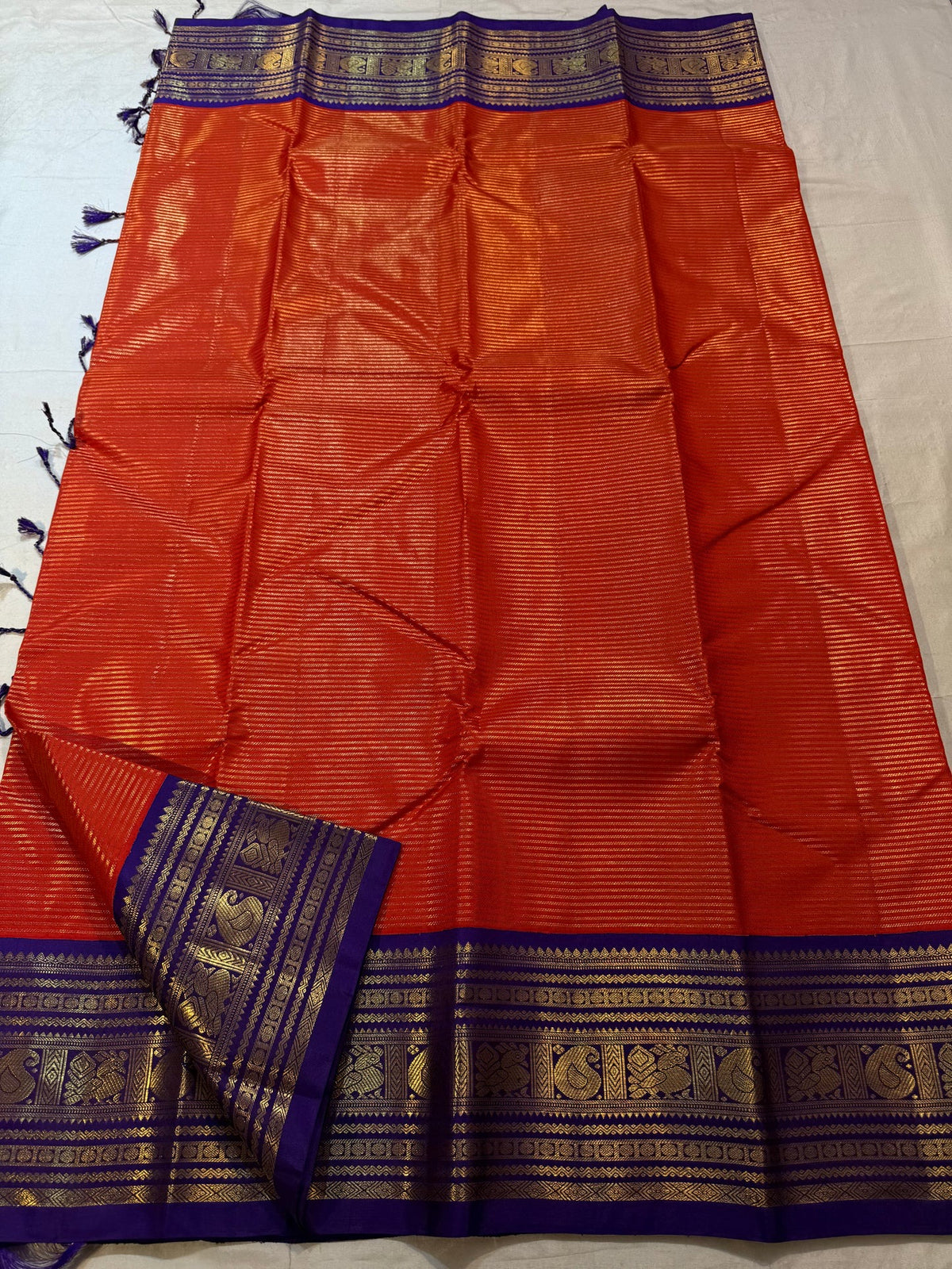 Burnt Orange Kanchipuram silk saree with fine antique-gold zari lines.