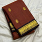 Close view of antique-gold zari buttas woven on Burnt Rust Kanjivaram silk.