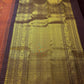 Burnt Rust Kanchipuram silk saree with individually spaced antique-gold zari buttas.