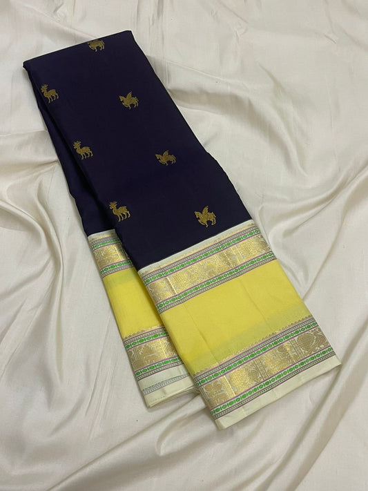 butter yellow kancheevaram silk saree with contrast blue border closeup
