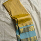 Long-folded butter yellow Pure Kanchipuram silk saree with small buttas and sky blue zari woven border detail