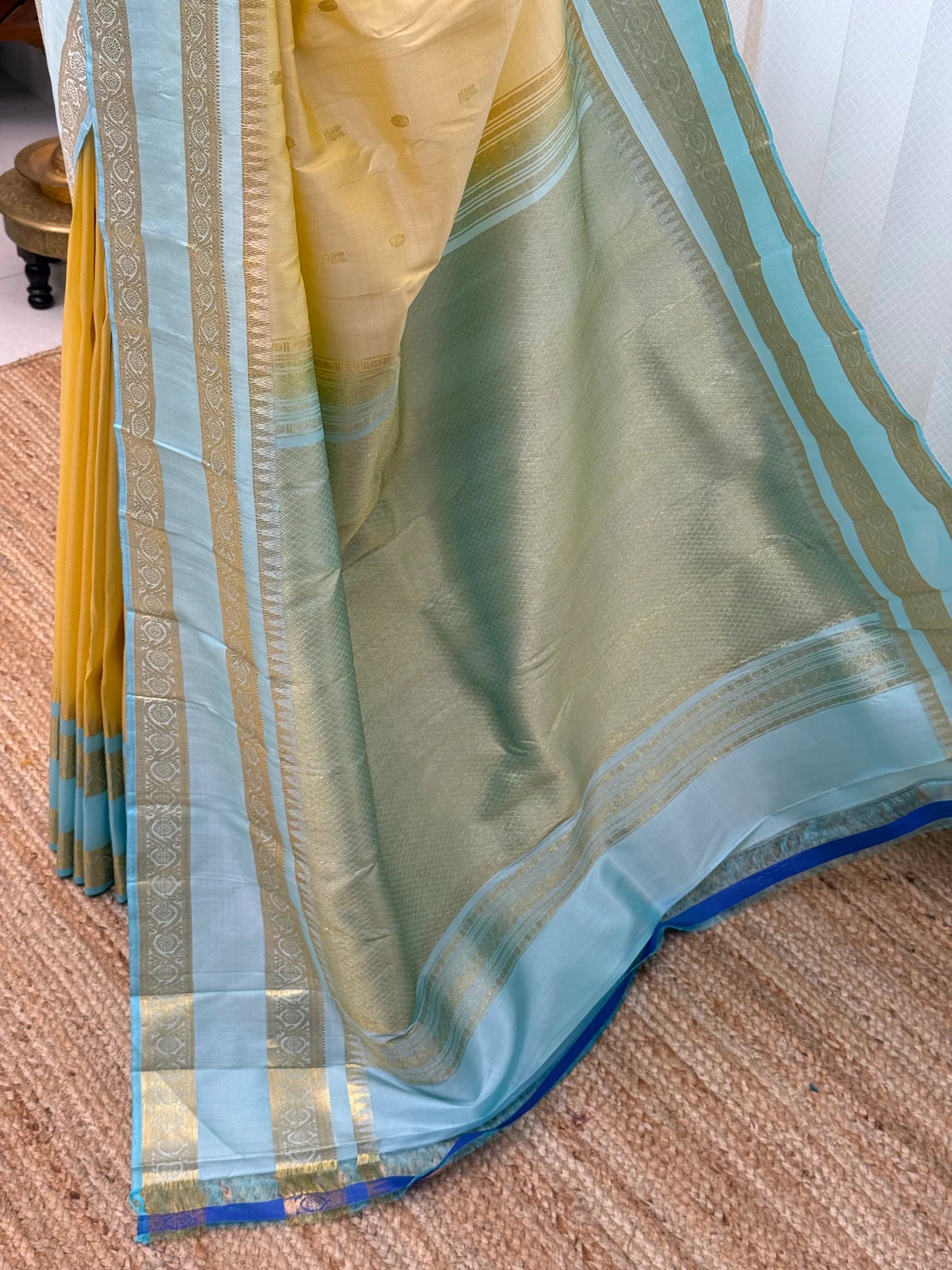 Close view of gold-toned pallu area with sky blue edge and zari woven border, available in the USA