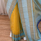 Pleated butter yellow Pure Kanchipuram silk saree showing sky blue border with wide zari woven motif band