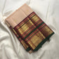 Soft peach ivory Kanchi Pattu silk saree with gold buttas and maroon forest green border.