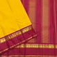 Arakku red Korvai border of canary yellow Kanjeevaram saree with Kaal Irangiya temple edge and paisley peacock antique gold zari