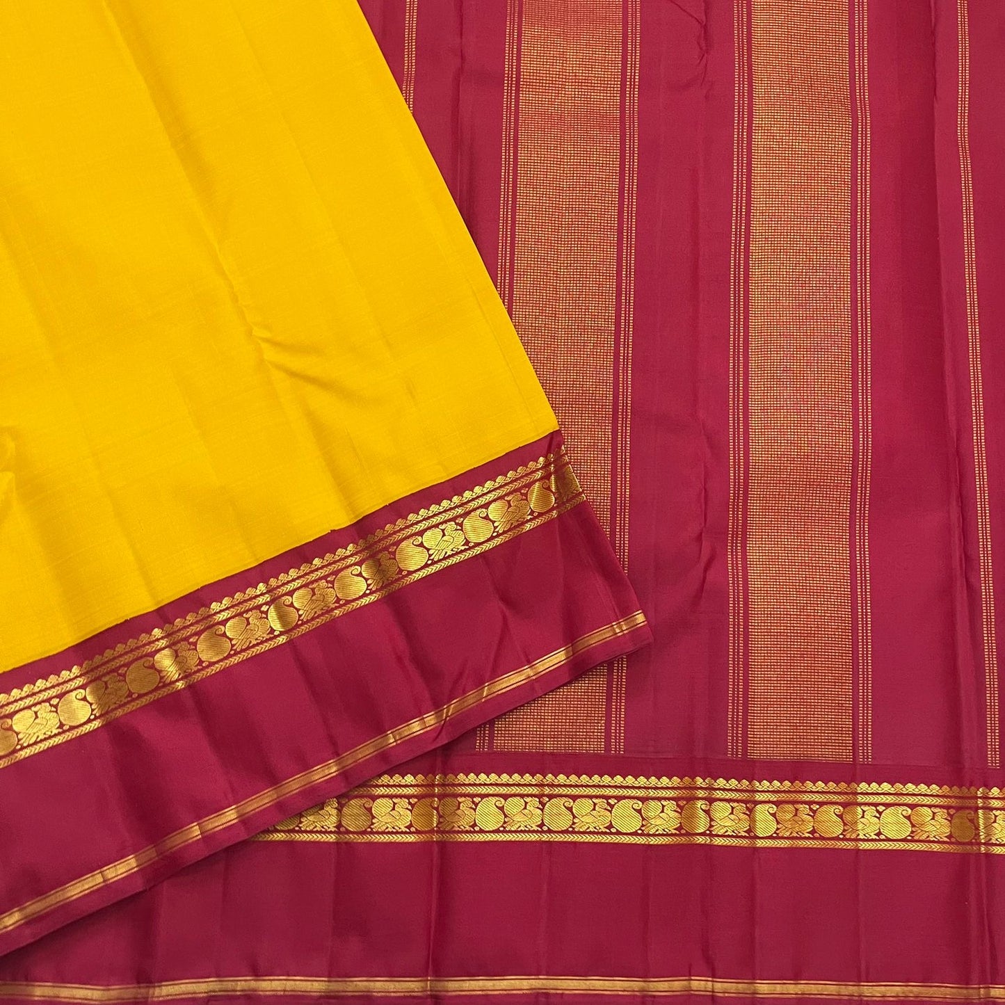 Arakku red Korvai border of canary yellow Kanjeevaram saree with Kaal Irangiya temple edge and paisley peacock antique gold zari