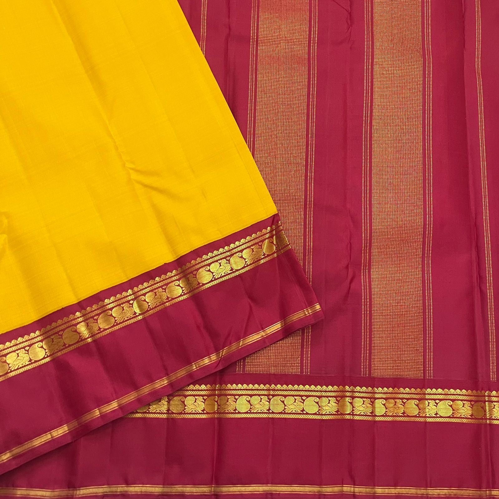 Arakku red Korvai border of canary yellow Kanjeevaram saree with Kaal Irangiya temple edge and paisley peacock antique gold zari