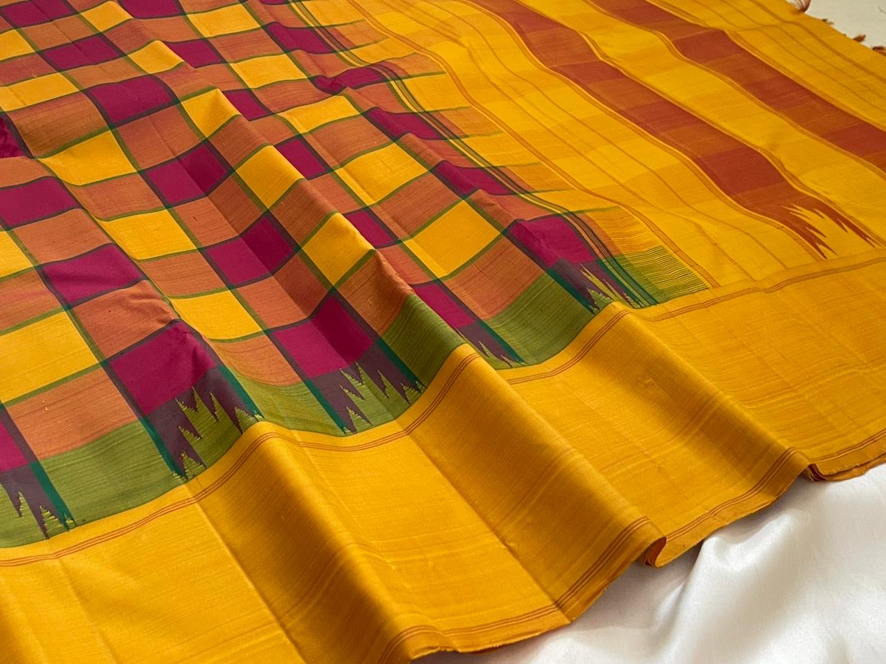 Olive green Thazhampoo Reku border of canary yellow Kanjivaram pure silk saree with Kaal Irangiya temple motif