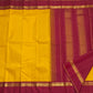Arakku red pallu of canary yellow Kanjeevaram pure silk saree with Kaal Irangiya and paisley antique gold zari cascade