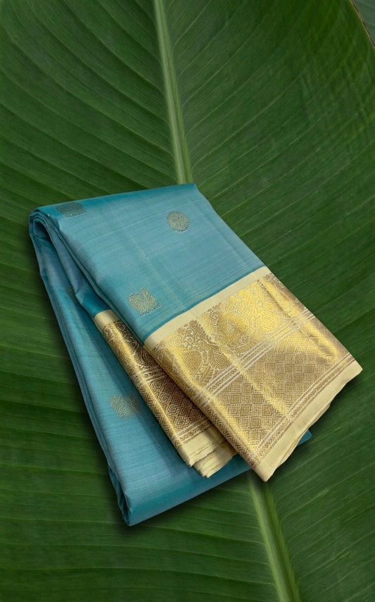 Celestial aqua Kanchipuram silk saree with ivory korvai border and mayil chakram zari butta folded view