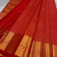 Chakram medallions and traditional bird motifs on the Sevappu Red gold-zari border.