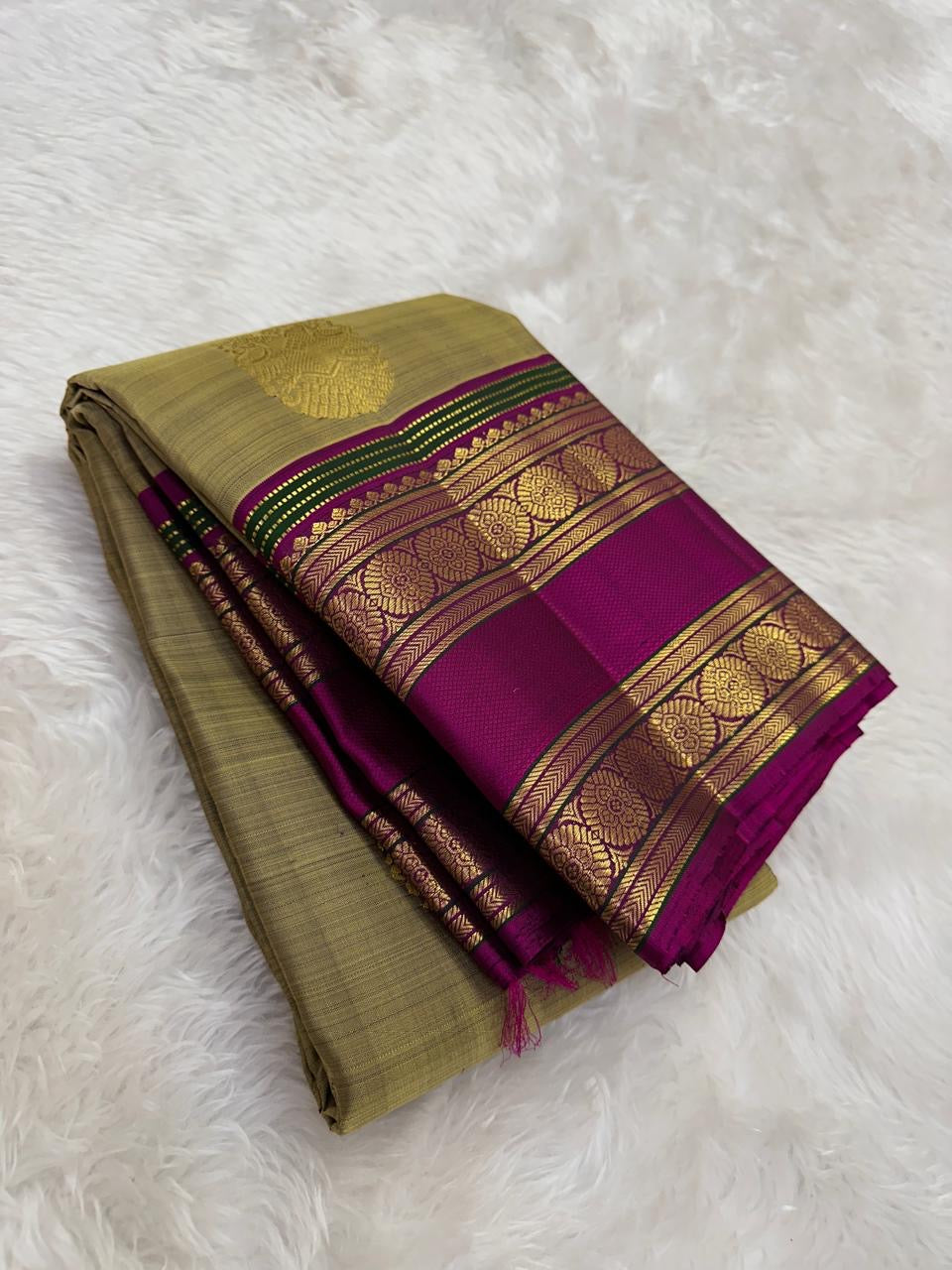 Champagne gold Kanjipuram Rettapet pure silk saree, folded view.